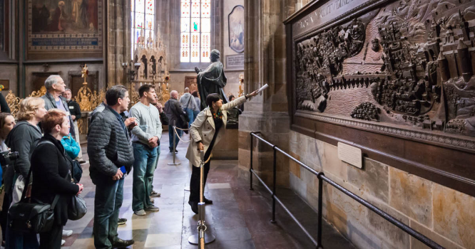 Museum tour guide explaining artwork on incentive travel trip
